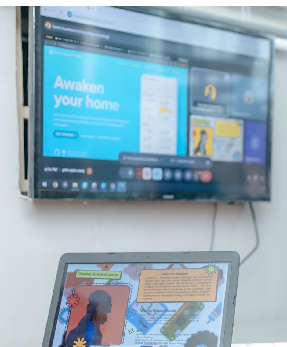 A Pi Jam session in Uyo, with a talk on screen and a laptop open on the bench.